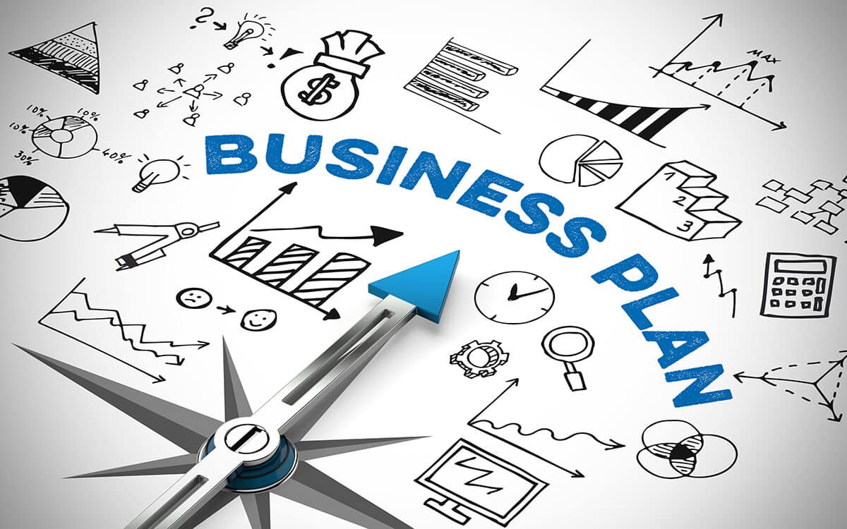 Business Plan mit Kompass und vielen Symbolen und Diagrammen